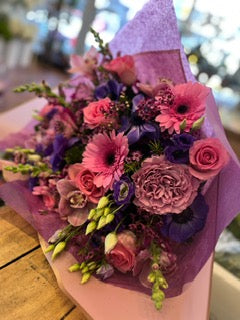 Field of Dreams upright: pink gerberas, pink roses and purple anemones with snapdragons in lavender wrap