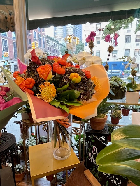 PumpKing small size: orange roses, pincushions, mini pumpkins and antique hydrangea in orange wrap, in a glass vase