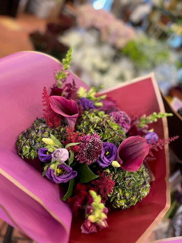 Green Envy, small size: green hydrangea with burgundy callas, purple lisianthus, scabiosa and red astilbe in magenta paper