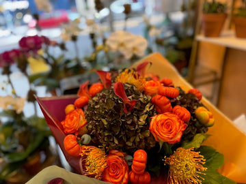 PumpKing with antique hydrangea, orange roses, orange calla lilies, pincushions and mini pumpkins, in the shop