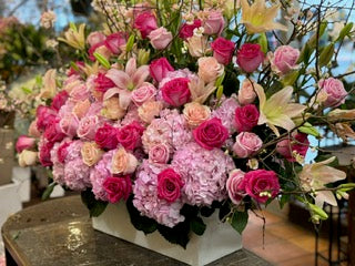 Knockout small size, pink hydrangea, hot pink, blush and peach roses with pink and white lilies in a white box