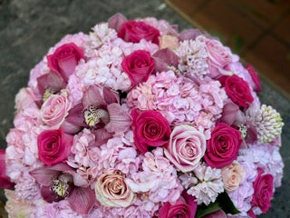 Jab, large size: close top view of pink hydrangea, hot pink roses, pink cymbidium orchids, peach roses and white hyacinth