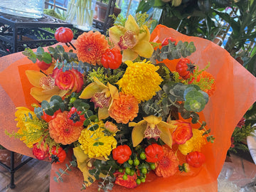Fall in Love, medium without vase: orange dahlias, yellow mums, yellow cymbidium orchids, roses and mini pumpkins
