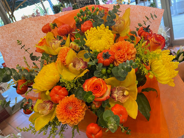 Fall in Love, large without vase: yellow cymbidium orchids, orange dahlias, yellow mums, roses, mini pumpkins, eucalyptus