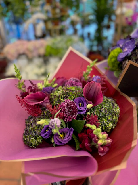 Green Envy: green antique hydrangea, burgundy calla lilies, purple lisianthus, scabiosa and astilbe in magenta wrap
