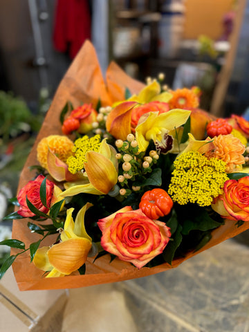 Fall in Love, medium with vase: orange roses, yellow callas, yarrow, a cymbidium orchid and mini pumpkins in orange wrap