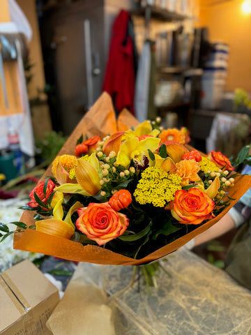 Fall in Love, large with vase: orange roses, yellow callas and yarrow with berries and mini pumpkins, held in orange wrap