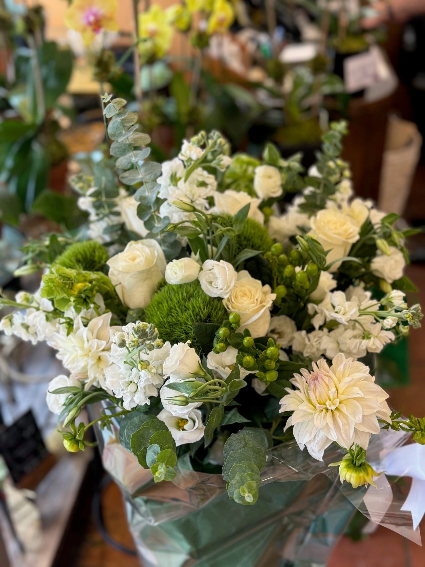 Erly Afternoon, small with vase: white and cream roses, dahlia and stock with green berries, wrapped in cellophane
