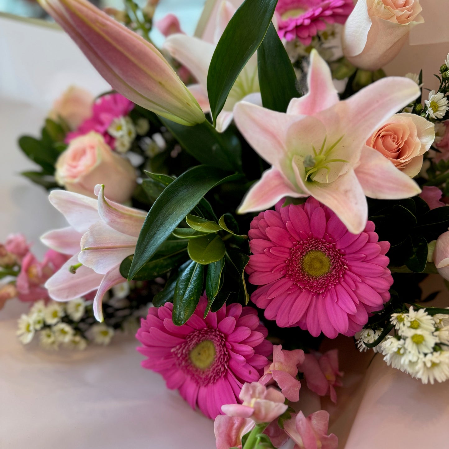Pink Passion large size: pink lilies, hot pink gerbera daisies, peach roses, snapdragons and white daisies in blush wrap