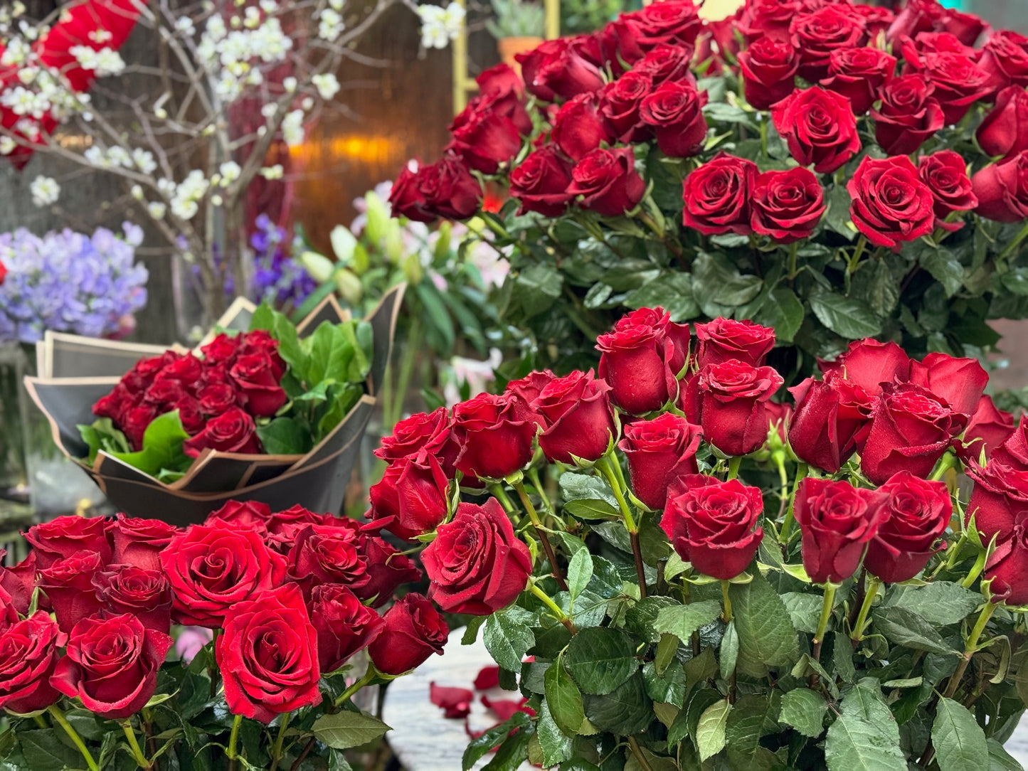 Complete Love close-up of red rose heads across the bouquet and the vase arrangements