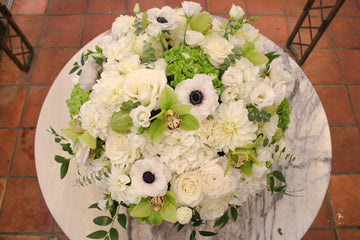 Golden Valentina from above: white roses, black-centered white anemones, a white dahlia, green hydrangea and green orchids