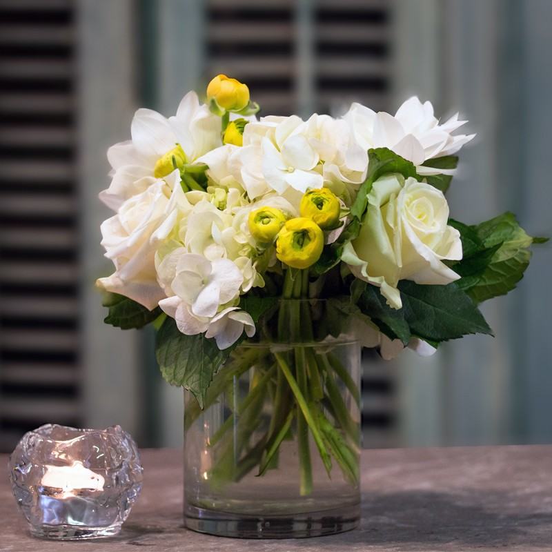 Simply Yellow & White, white roses and white hydrangea with yellow ranunculus buds in a clear glass cylinder vase