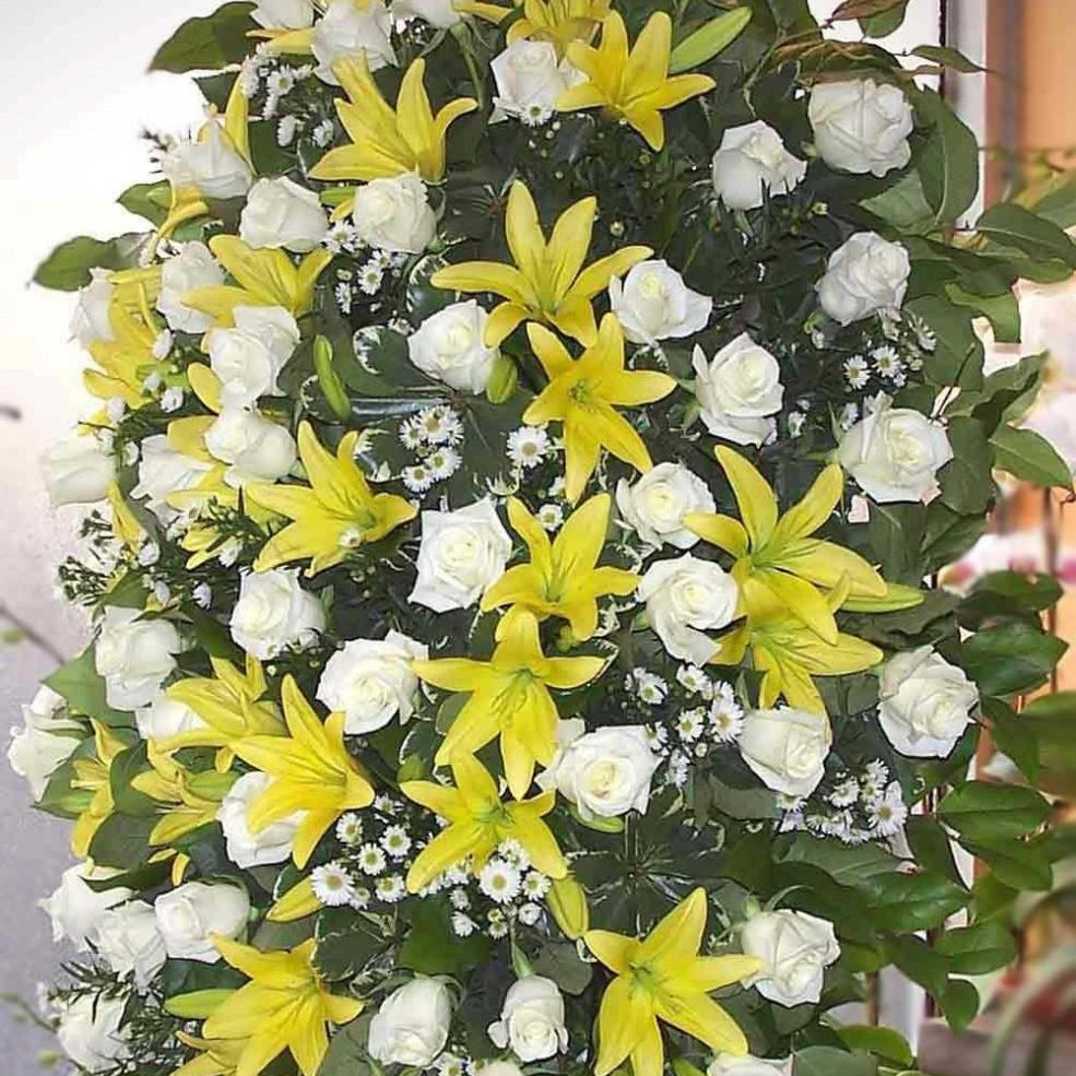 Tranquility small size, spray of white roses, yellow lilies and small white daisies with greenery