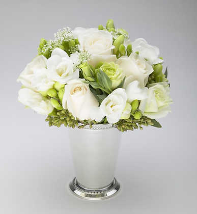 Petite white roses and white freesia with green berries in a silver julep cup