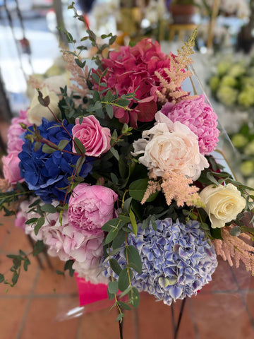 
                    
                      Punch H side view: blue and lilac hydrangea, pink and blush peonies, cream roses and pink astilbe with eucalyptus
                    
                  