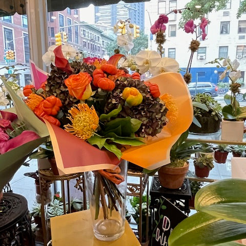 PumpKing small size: orange roses, pincushions, mini pumpkins and antique hydrangea in orange wrap, in a glass vase