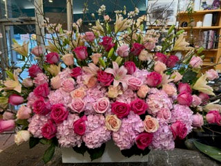
                    
                      Knockout medium size, pink hydrangea, hot pink and peach roses with pink and white lilies and white branches in a white box
                    
                  