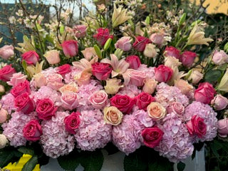 
                    
                      Knockout large size, close front view of pink hydrangea, hot pink, blush and peach roses and pink lilies in a white box
                    
                  