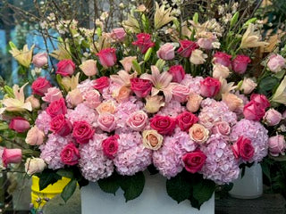 
                    
                      Knockout front view, pink hydrangea, hot pink, blush and peach roses with pink and cream lilies in a white box
                    
                  