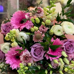 Good Vibes: pink gerbera daisies, lavender roses, white ranunculus and green snapdragons, hand-tied with pink wrap