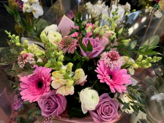 
                    
                      Good Vibes from above: pink gerbera daisies, lavender roses and white ranunculus with pale green snapdragons
                    
                  