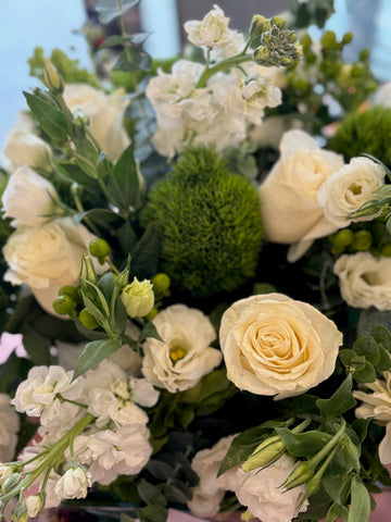 
                    
                      Erly Afternoon, small without vase: close-up of a cream rose, white lisianthus and stock around a green dianthus ball
                    
                  