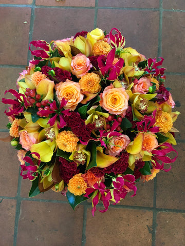 
                    
                      Red Berry seen from above: orange roses and dahlias, gloriosa lilies, yellow callas, cymbidium orchids and red berries
                    
                  