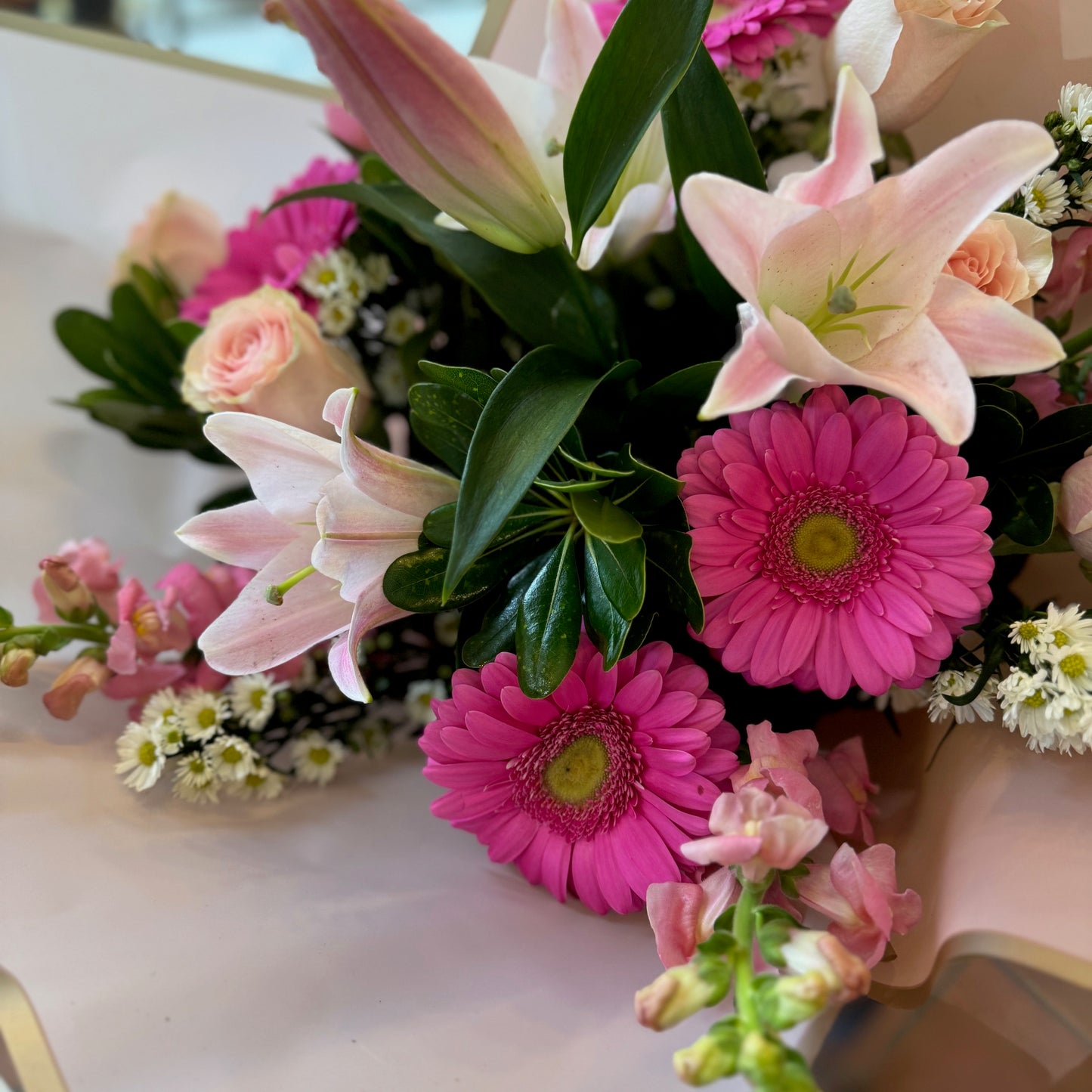 Pink Passion, also the Love me sample: pink lilies, hot pink gerberas, peach roses and pink snapdragons in blush paper
