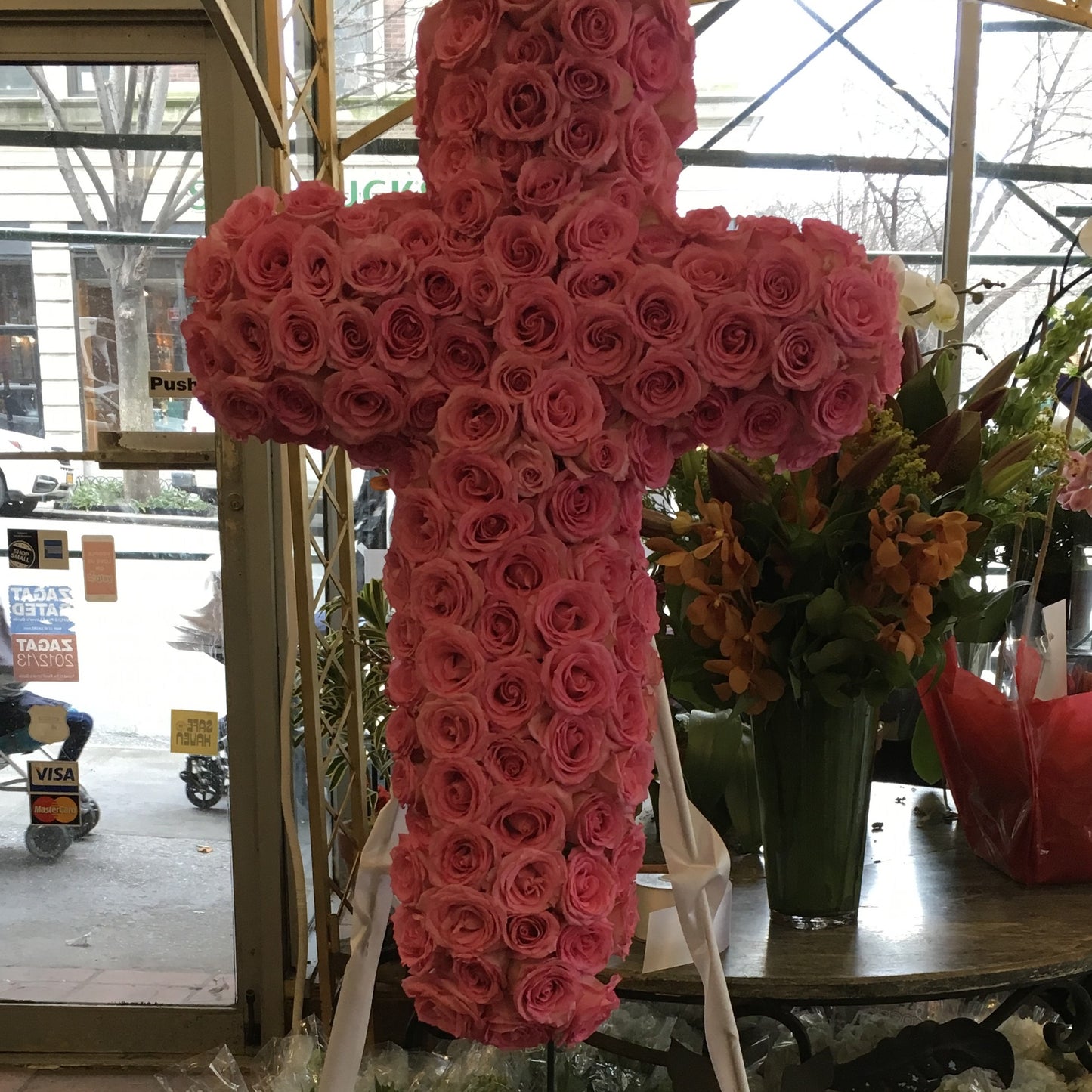 Sympathy - Boundless Love large size, close-up of a standing cross covered in pink roses with white ribbon